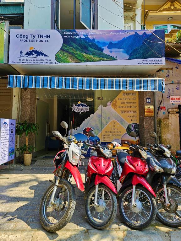 a row of motorcycles parked in front of a building at Frontier Hostel & Tours in Dien Bien Phu