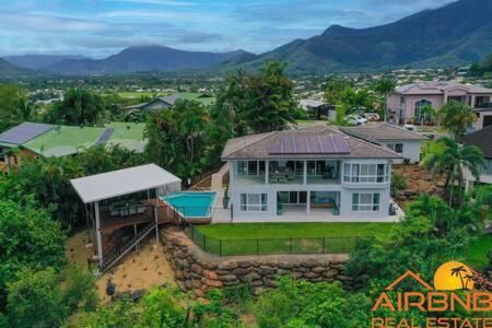 an aerial view of a large white house at Mount Sheridan home with Breath taking views in Cairns