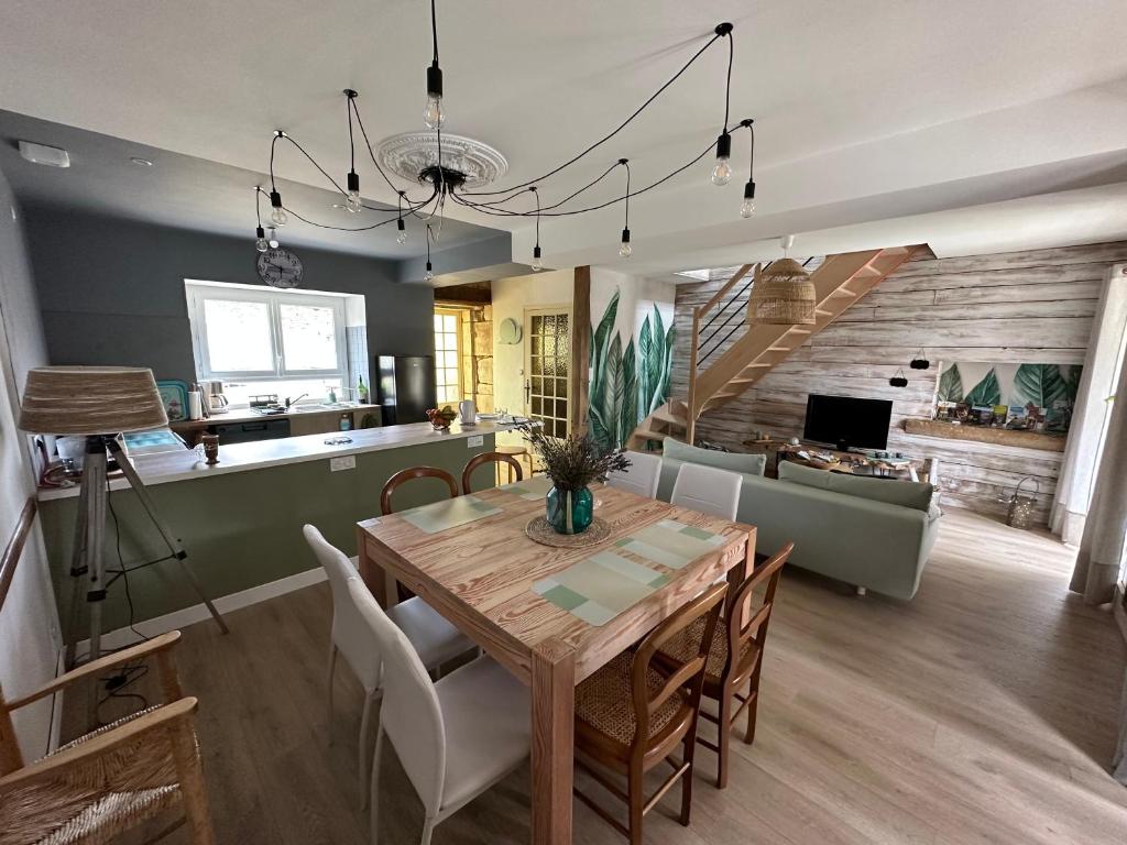 une salle à manger et un salon avec une table et des chaises dans l'établissement La tinoche, à Sauvigny-le-Bois