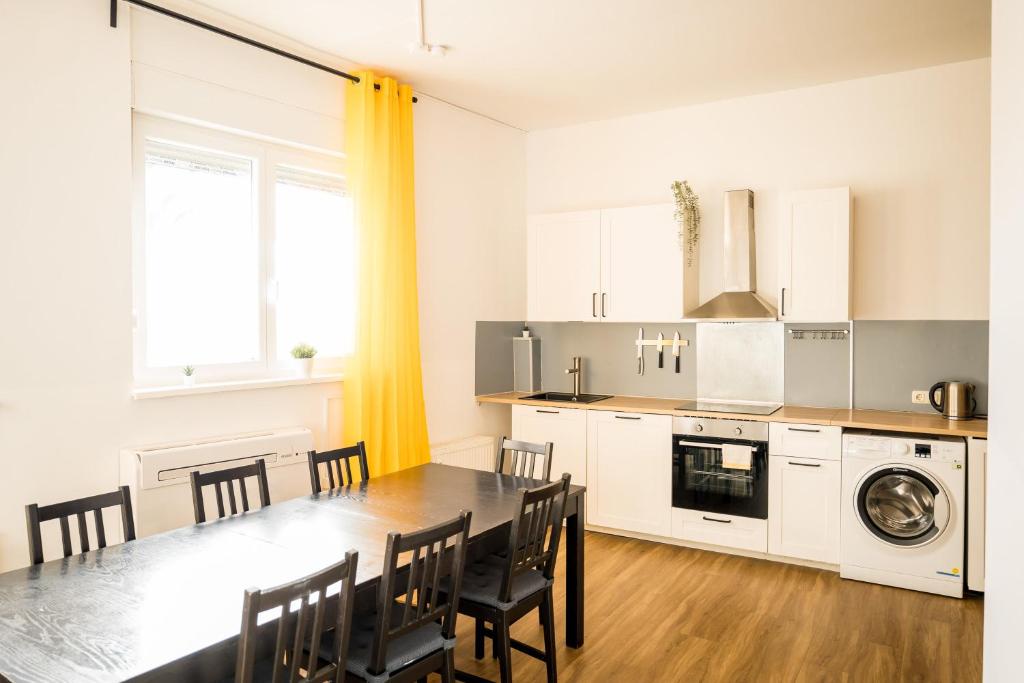 a kitchen and dining room with a table and chairs at Three Bedroom plus big kitchen plus SelfCheckIn plus Street Parking in Berlin