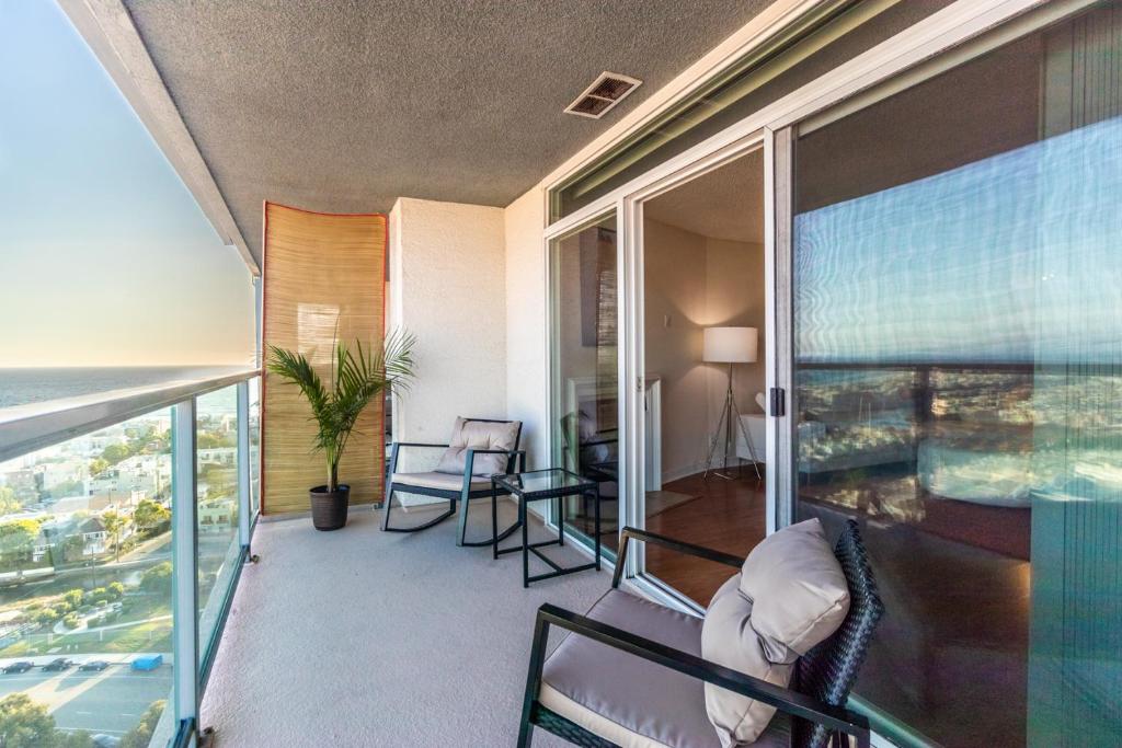 a balcony of a condo with a view of the ocean at Stylish & Bright 2BDR & 2BTH Redondo B Ocean Views in Redondo Beach