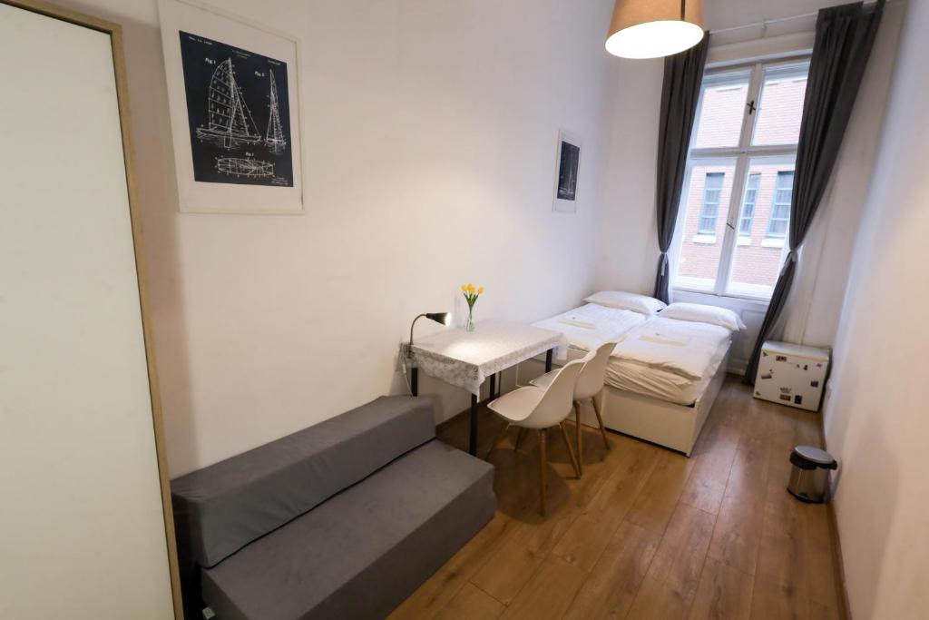 a small room with a table and chairs and a window at Budapest Pest-port apartment 4 rooms for 16 person in Budapest