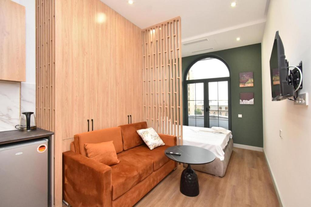a living room with a couch and a table at Aygestan plaza apartment 5 in Yerevan