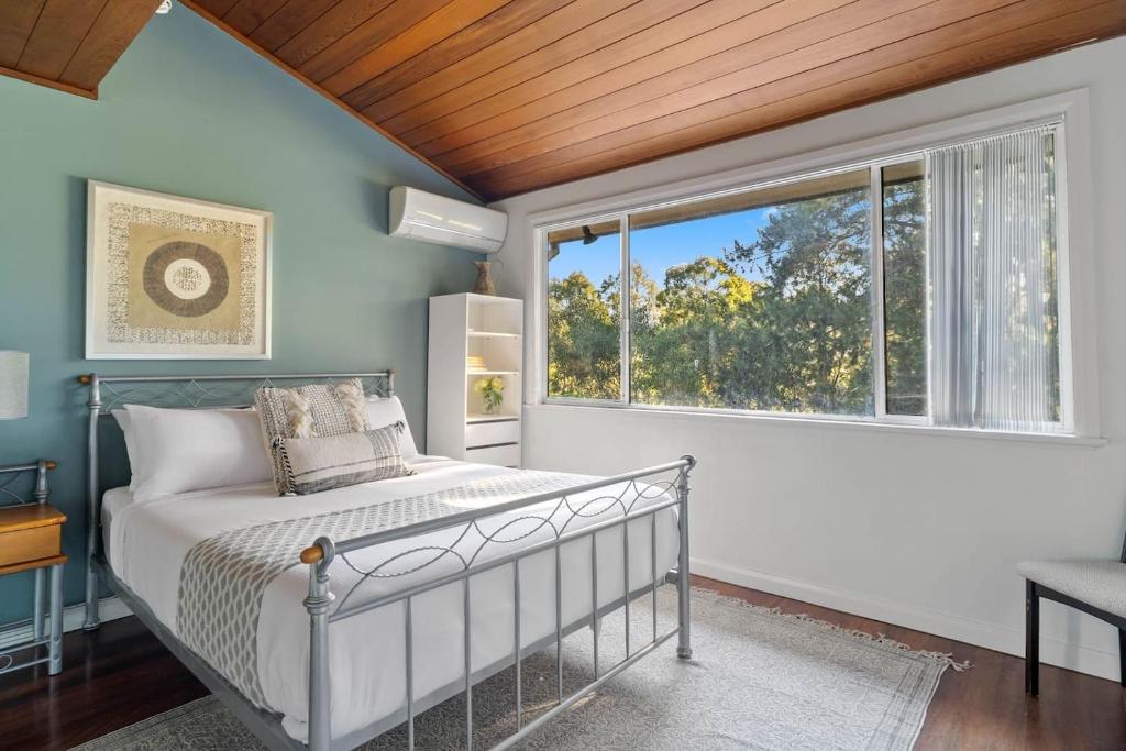 a bedroom with a bed and a window at The Young - A Peaceful Parkside Delight in Sydney