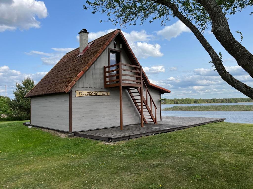 a small building with a roof on a dock at Rõsna Puhkekeskus in Rõsna