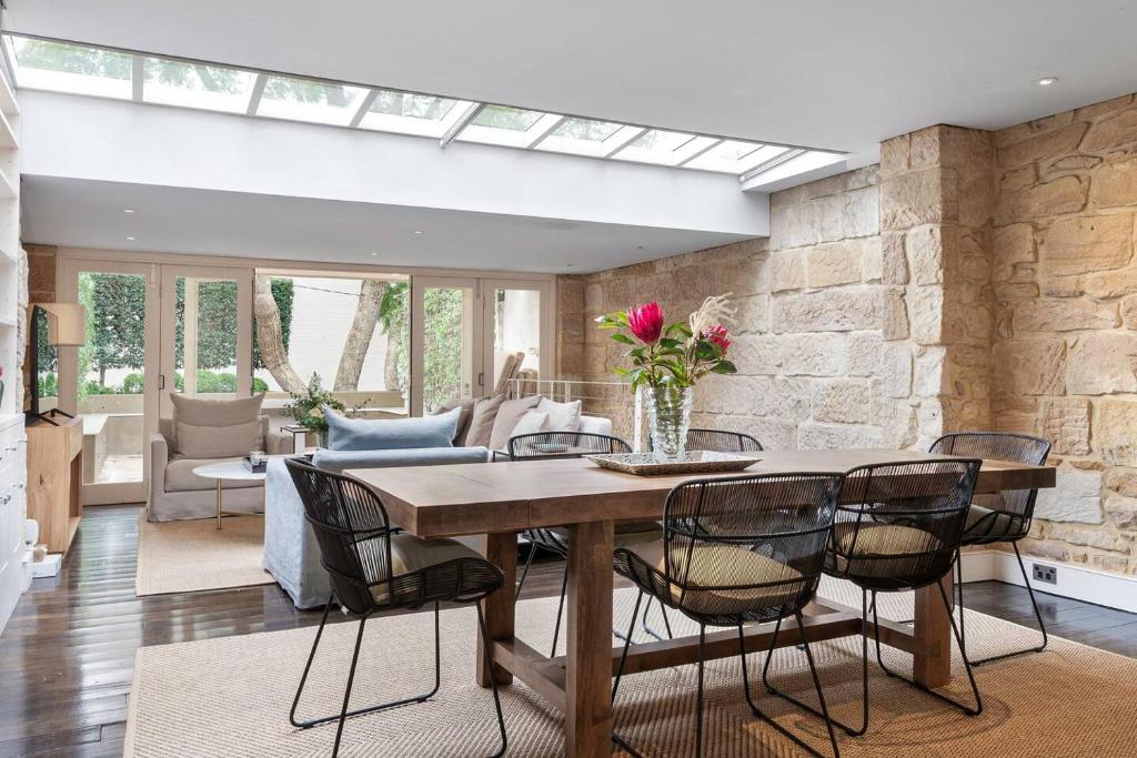 雪梨的住宿－Elegant Paddington Sandstone Cottage with Parking，一间带桌椅的用餐室