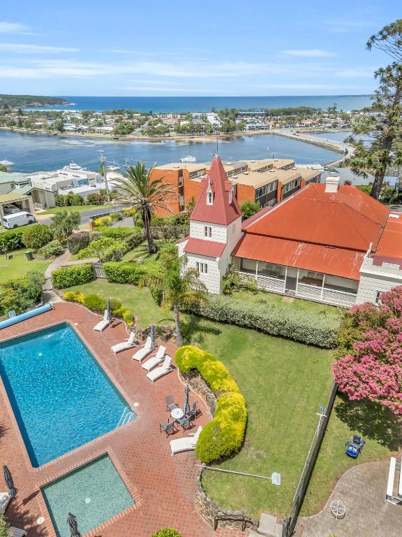 an aerial view of a house with a swimming pool at Munns Tower House in Merimbula