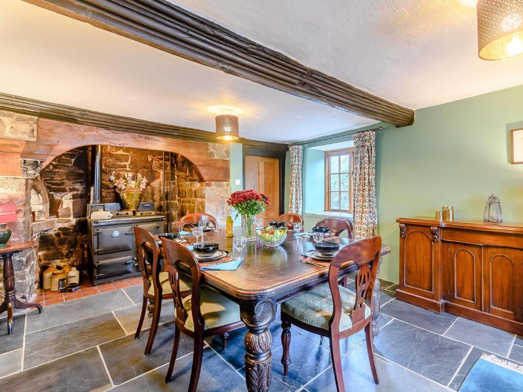 a dining room with a wooden table and chairs at 2 Bed in Tiverton 77884 in Bolham