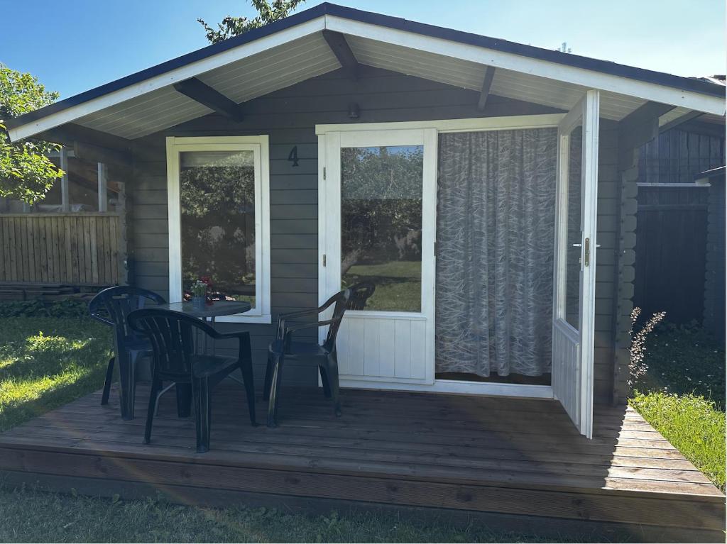 un patio con mesa y sillas en una terraza en Hede suvemajad/summer houses, en Pärnu