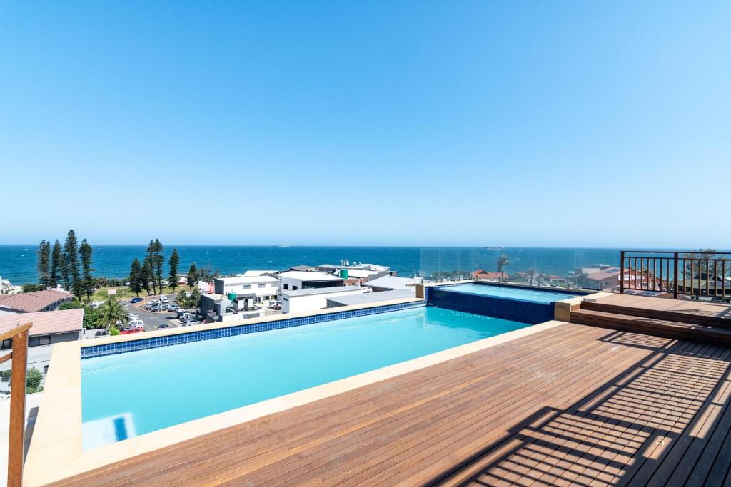 a swimming pool with a view of the ocean at Shanthi Apartment 8 in Ballito