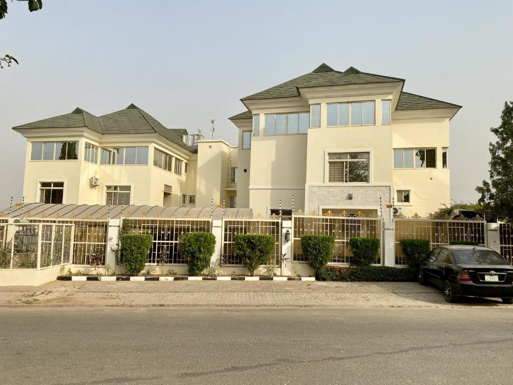 a house with a car parked in front of it at GLOVIS LUXURY APARTMENT in Abuja