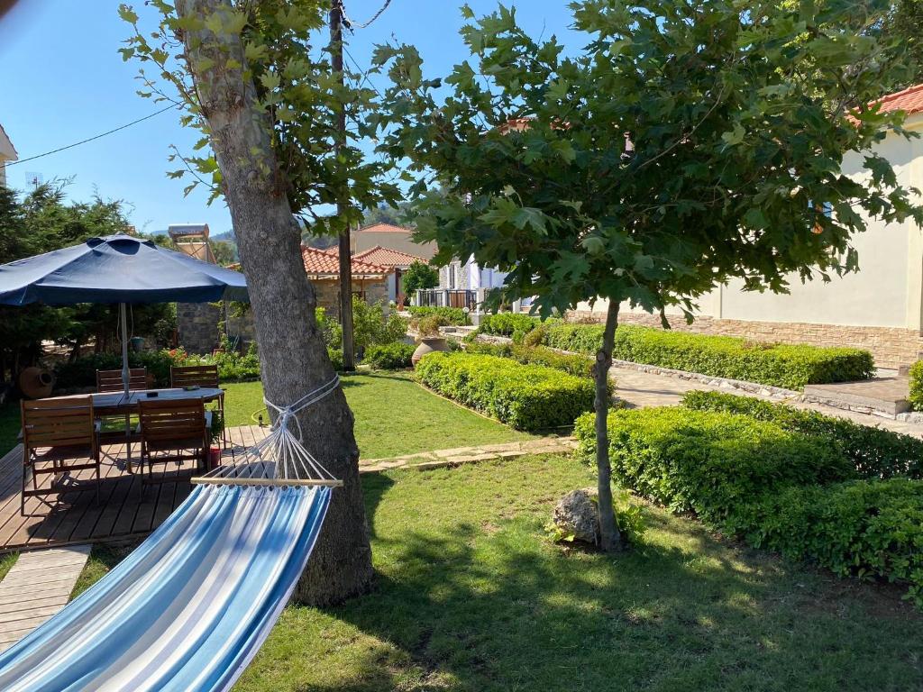 a hammock tied to a tree in a yard at Christina Sea View in Ágios Konstantínos