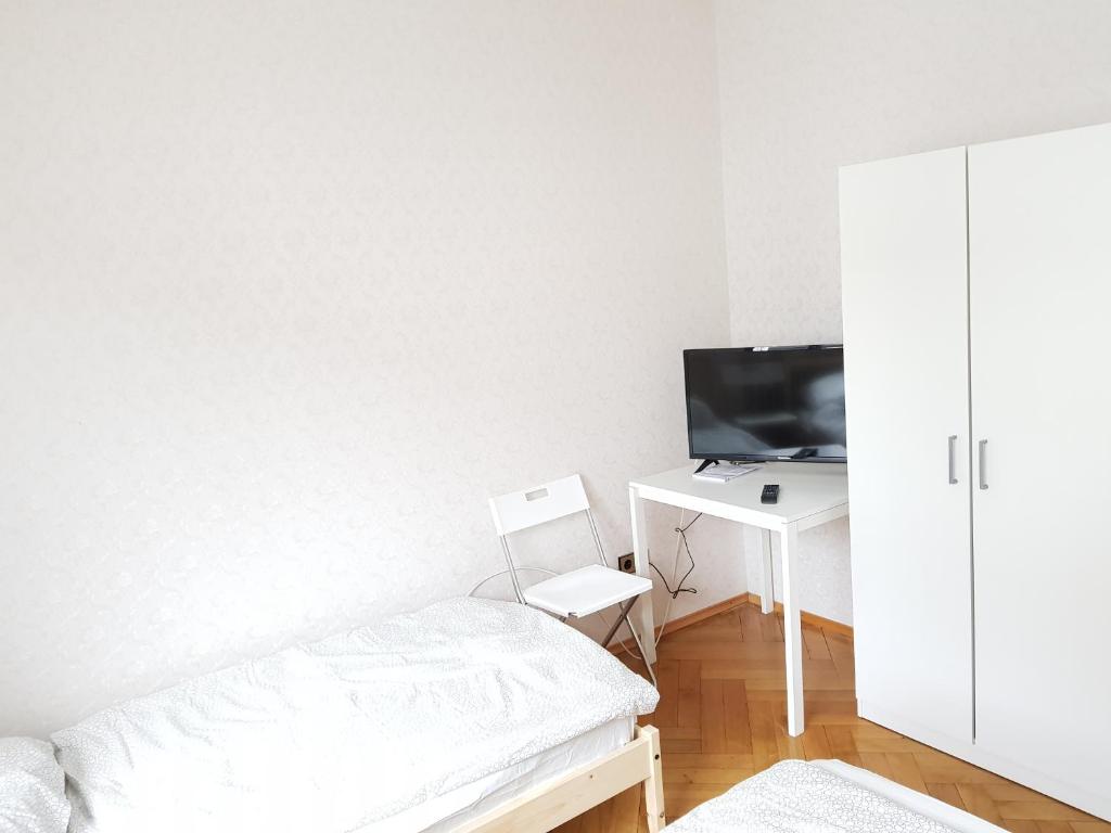a bedroom with a bed and a desk with a computer at Monteurswohnungen Bruchsal Süd in Bruchsal