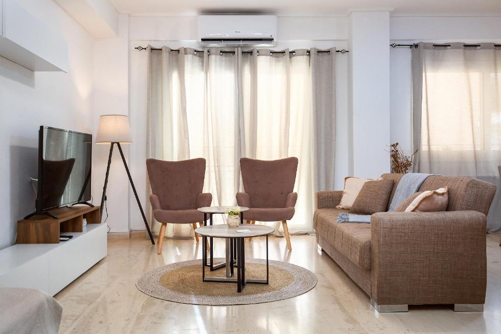 a living room with a couch and a tv at Harmony home in Ierapetra