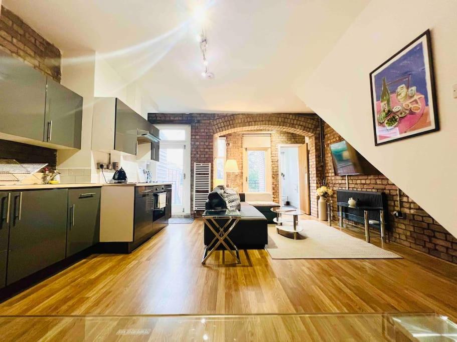 an open kitchen and living room in a loft at Highgate Garden Apartment- 2 Bed in London