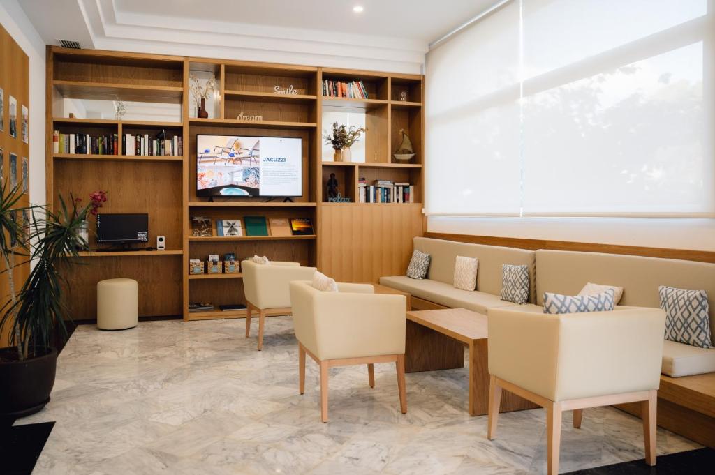 a waiting room with a couch and chairs at Comitas Floramar in Cala Galdana
