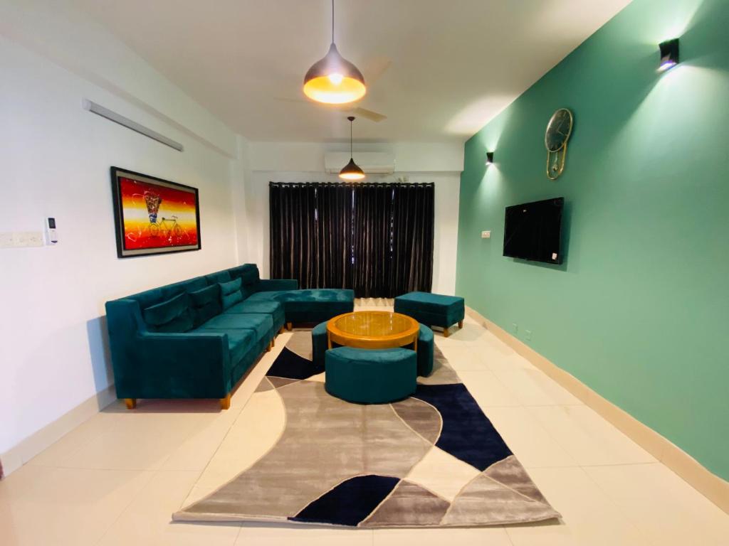 a living room with a couch and a table at Amazing Apartment in Bashundhara in Dhaka