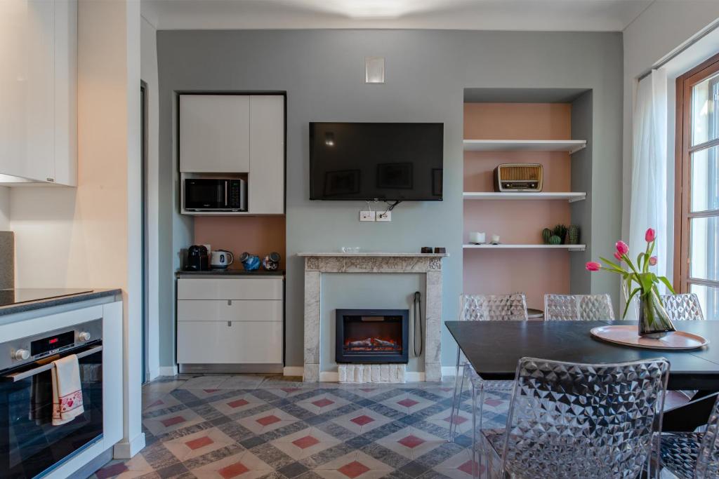 a living room with a table and a fireplace at Luxury For Groups & Families in city center in Turin
