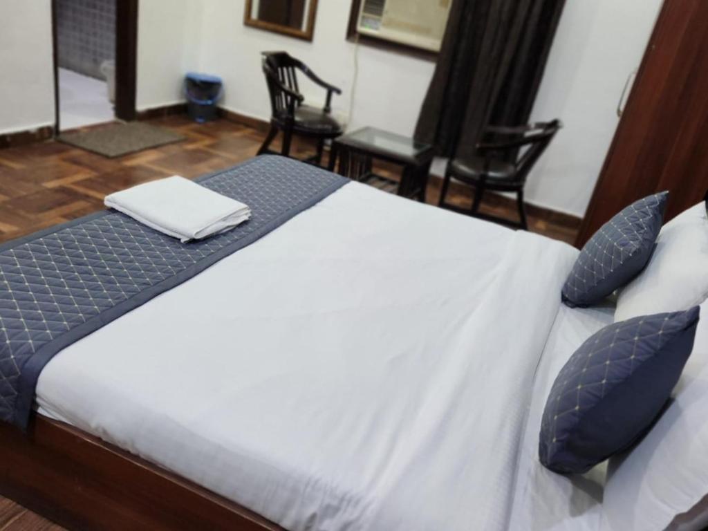 ein Schlafzimmer mit einem Bett mit blauen Kissen in der Unterkunft Hotel rose ivyy in Neu-Delhi