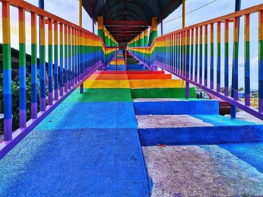 a stairway with rainbow paint on it at Comfort Stay Kuala Perlis Wi-Fi Nexflix in Kuala Perlis