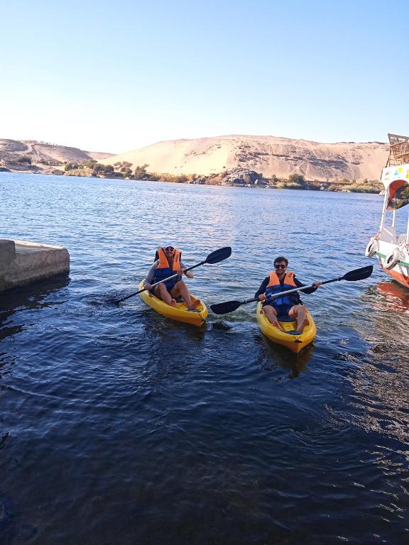 three people in kayaks on a body of water at Houseboat Hotel and Nile Cruises Zainoba in Nag` el-Ramla