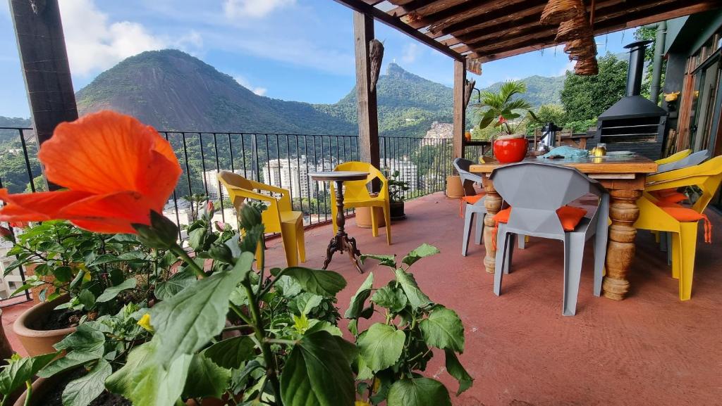 een patio met stoelen en een tafel met uitzicht op een berg bij Nid aigle 3 Suites in Rio de Janeiro