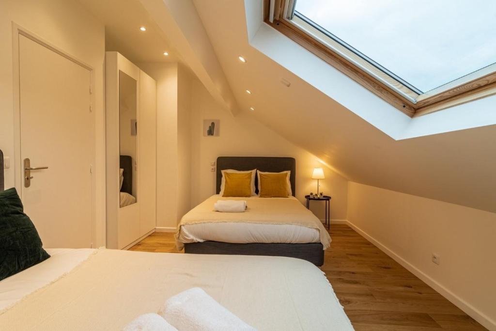 a attic bedroom with two beds and a skylight at Lille Centre - Nice cozy and functional ap in Lille