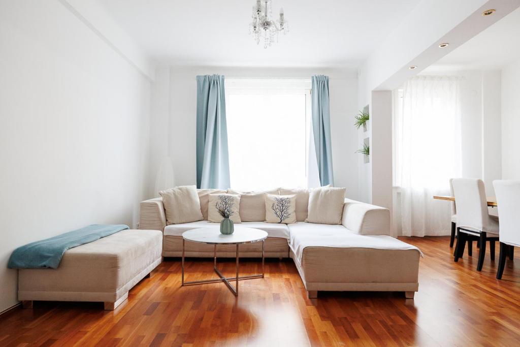 a living room with a couch and a table at Operastreet City-Center Premium Apartment in Vienna