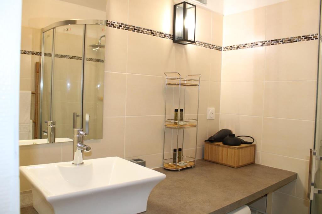 a bathroom with a sink and a shower at Au Pied du Viaduc in Morlaix