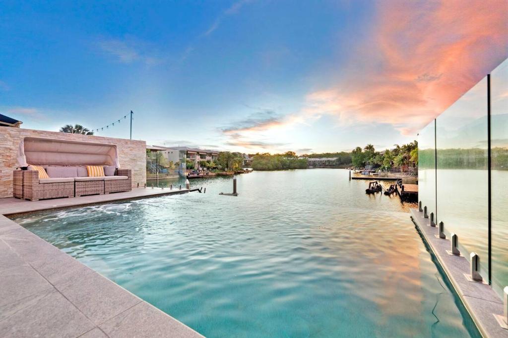 a swimming pool with a view of a river at 'Infinity's Edge' Darwin Luxury Waterfront Oasis in Darwin