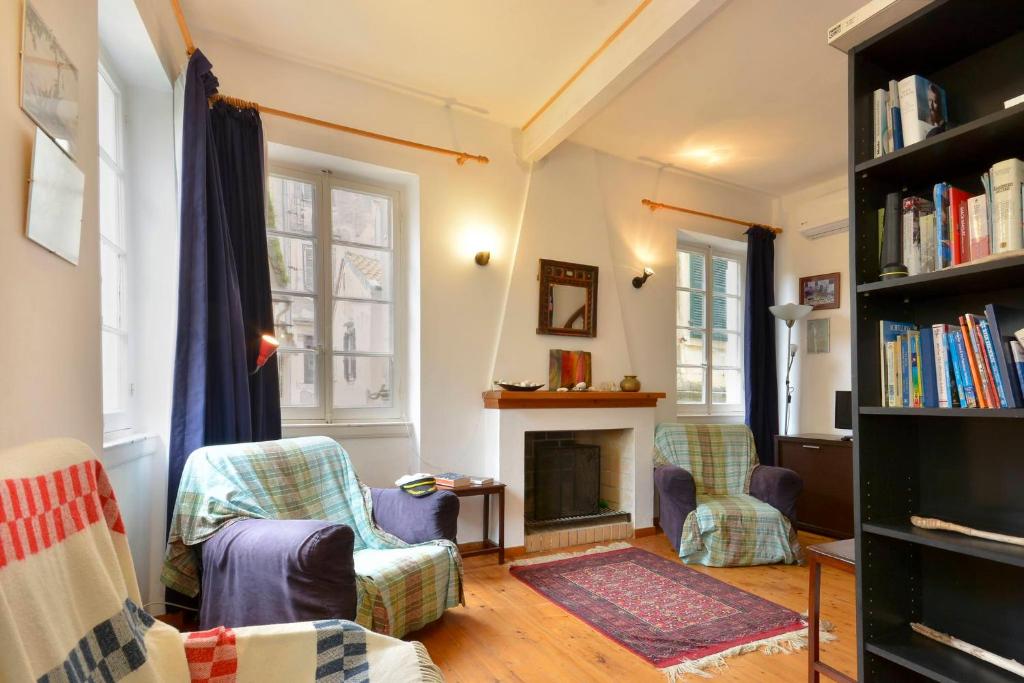 a living room with two chairs and a fireplace at Iliokambida house in Corfu