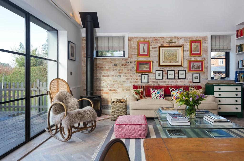 a living room with a brick wall at The Outbuilding Appledore in Snargate