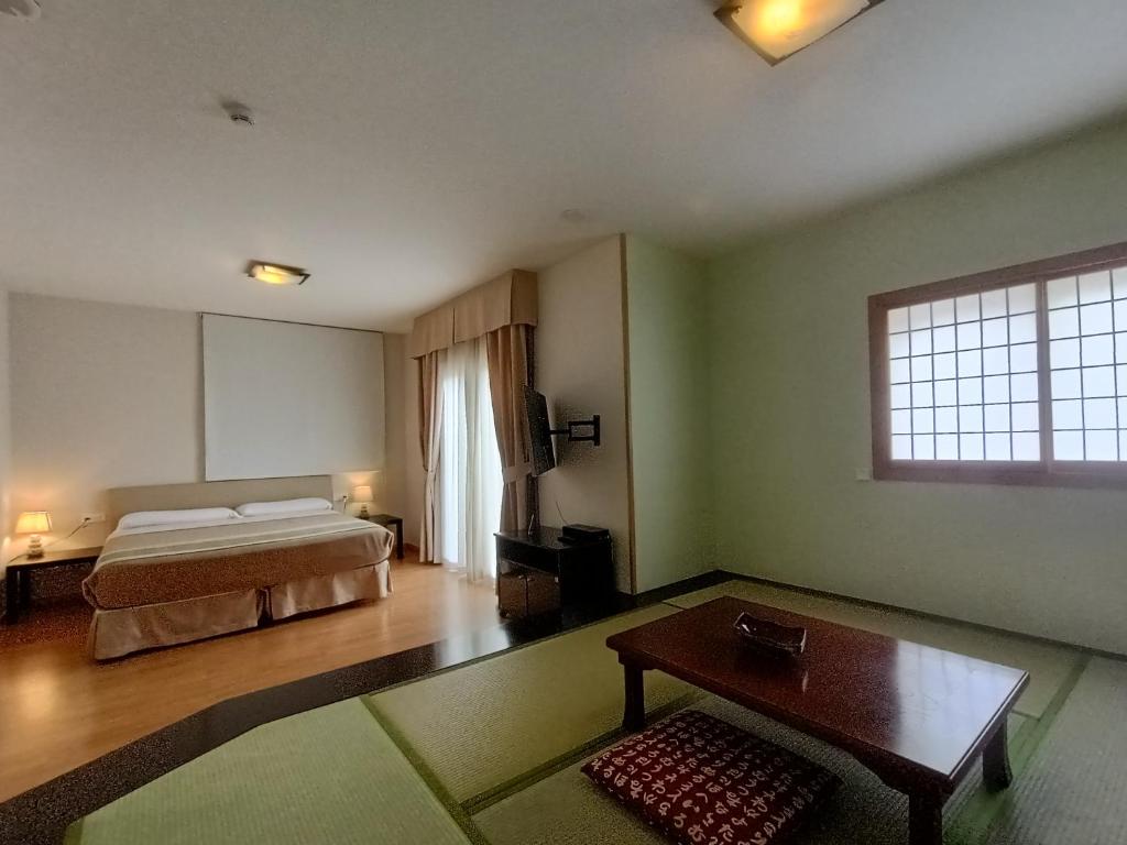 a hotel room with a bed and a table at La Luna Blanca in Torremolinos