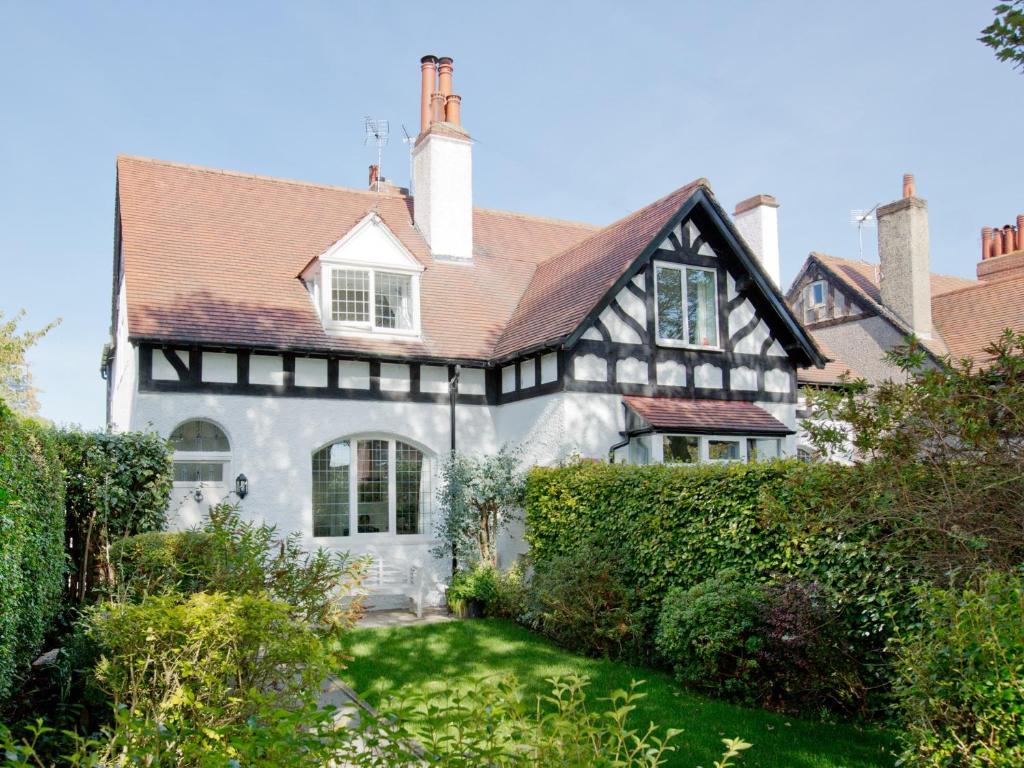 a white house with a black and white roof at 2 Bed in Harrogate 74981 in Harrogate