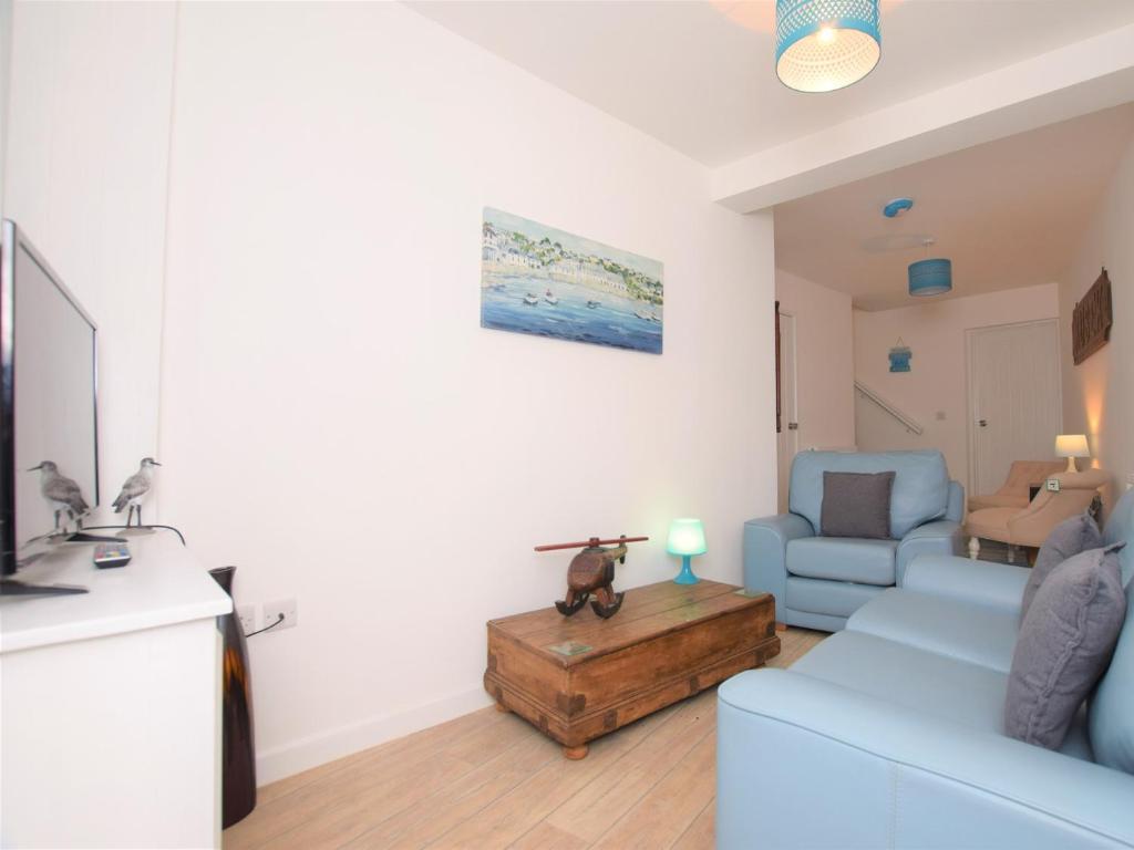 a living room with a blue couch and a table at 2 bed in Brixham 75549 in Brixham