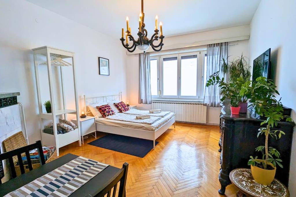 a living room with a couch and a chandelier at TRUE ZAGREB centrally located & spacious apartment in Zagreb
