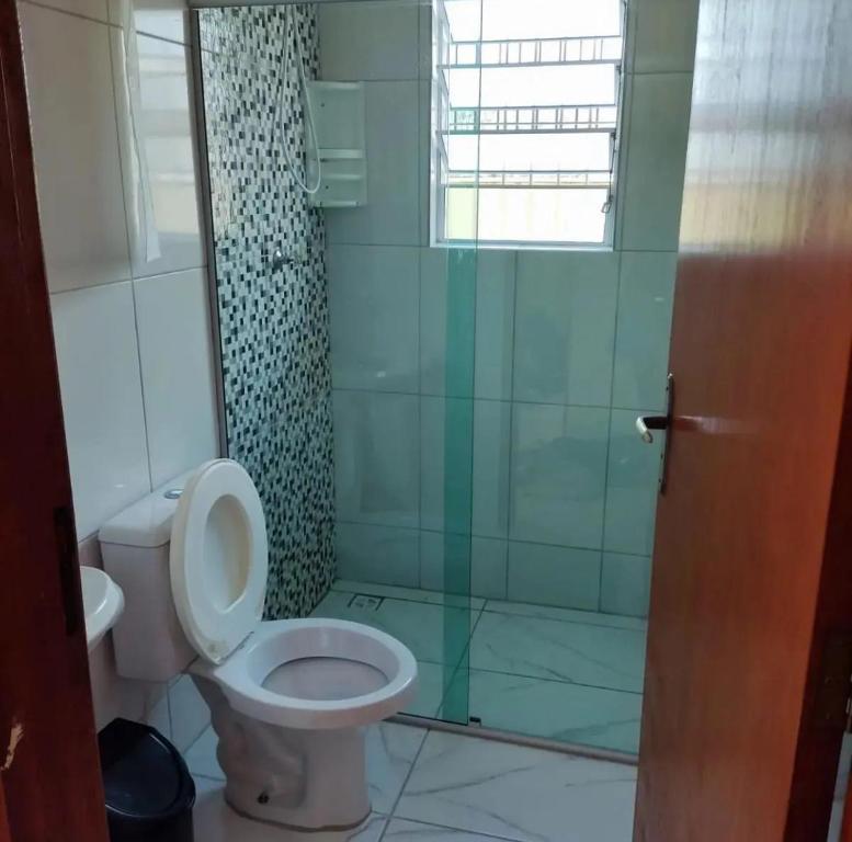 a bathroom with a toilet and a shower at Casa De Hóspede in Itu