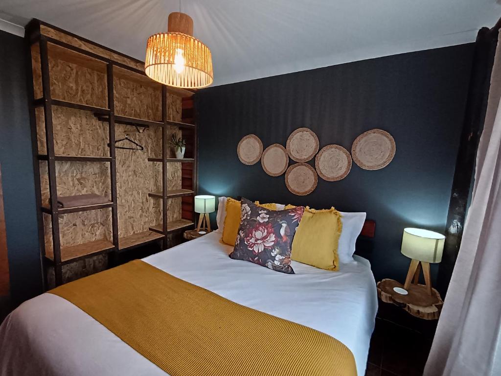 a bedroom with a bed with plates on the wall at The Wild Edge Last Light Cottage in Knysna