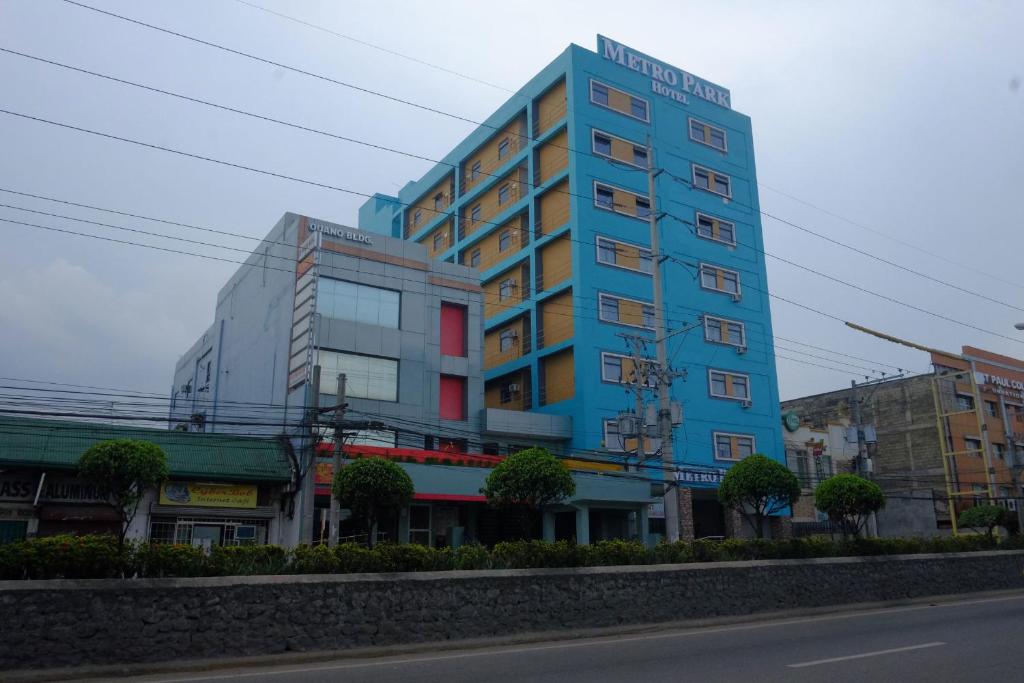 a blue building on the side of a street at Metro Park Hotel Mandaue in Cebu City