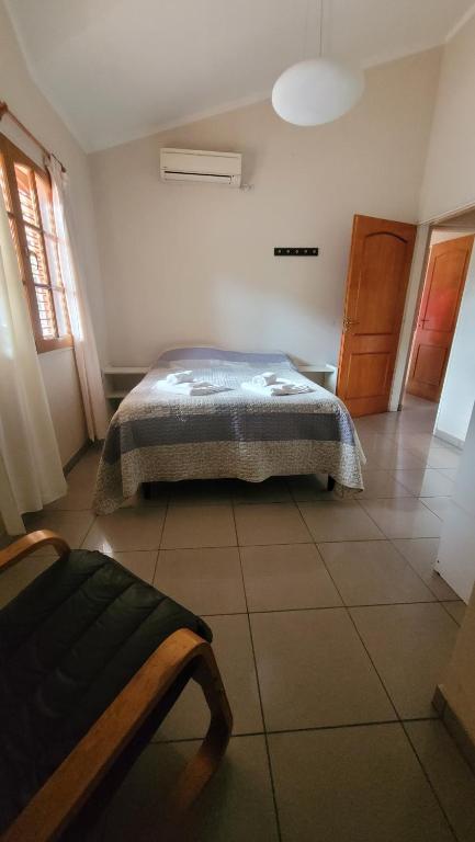 a bedroom with a bed in the corner of a room at Casiopea Apart in San Fernando del Valle de Catamarca
