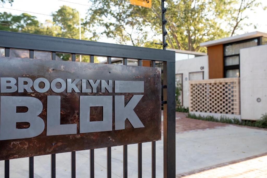 a sign that says brooklyn blk behind a fence at Brooklyn Blok in Pretoria