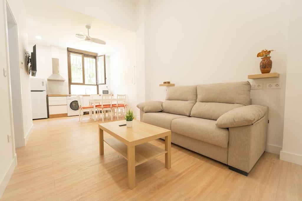 sala de estar con sofá y mesa en Apartamento a estrenar en San Bernardo en Sevilla