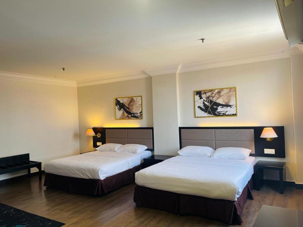 Postel nebo postele na pokoji v ubytování Remington Hotel