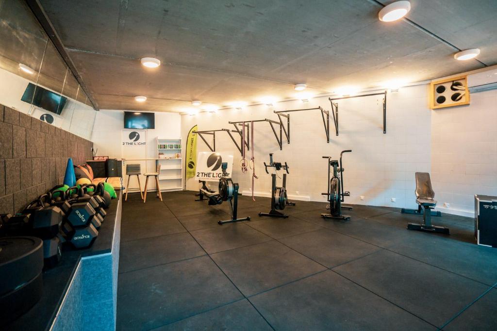 a gym with several exercise bikes on the wall at Glamping Bretagne in Quimper
