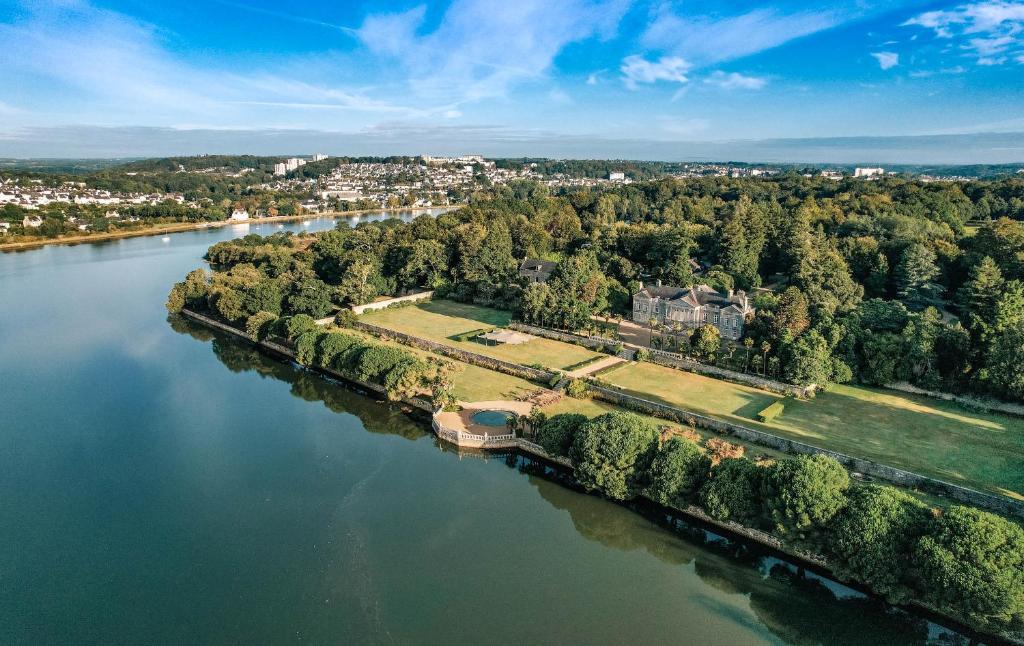an aerial view of a large estate on a river at Glamping Bretagne in Quimper