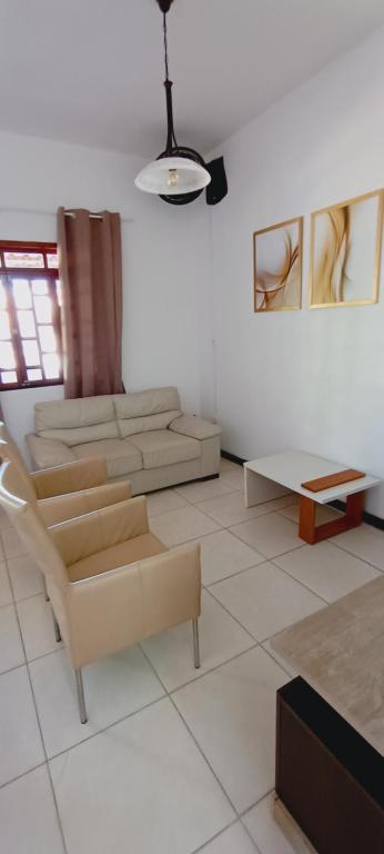 a living room with a couch and a table at Hóspede do Lar Amoroso Bed & Breakfast in Salvador