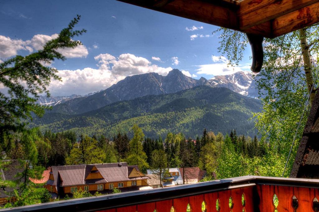 a view of a mountain range from a house at Willa Pod Orłem Jacuzzi Sauna in Kościelisko