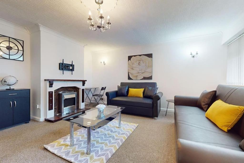 a living room with a couch and a fireplace at CONeN Dagenham Home in Goodmayes