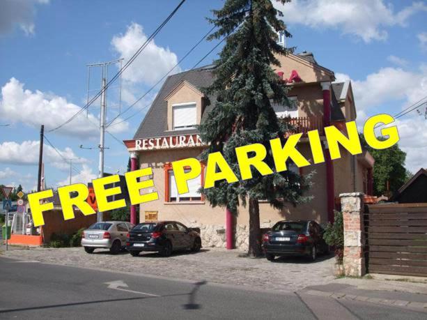 a free parking sign in front of a building at Attila Hotel in Budapest