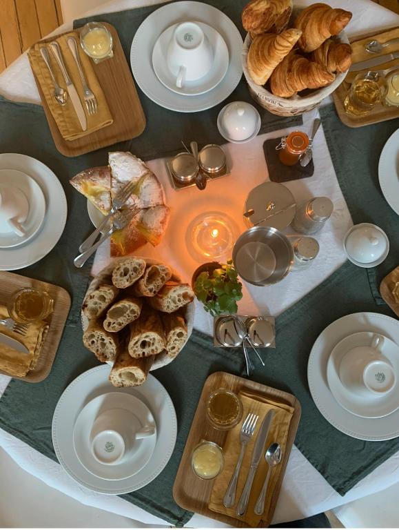 a table with plates of food and bread on it at La Demeure des Sacres - Cathédrale in Reims